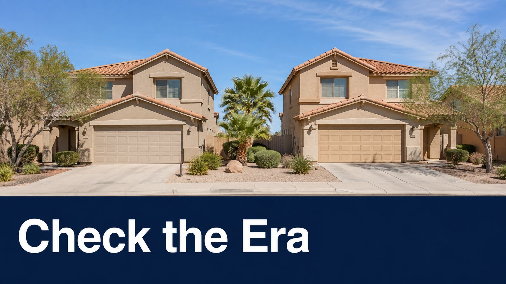 Two identical suburban beige houses featuring tile roofs and desert landscaping under a clear blue sky.